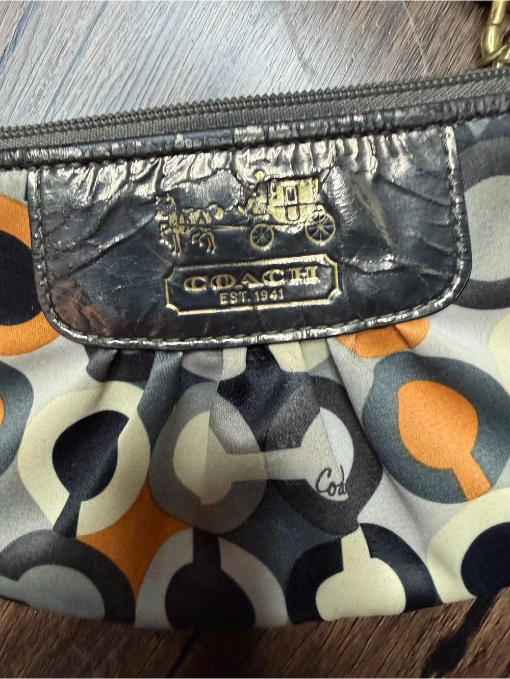 Coach Madison Graphic Op Art sateen Wristlet in Brown and Orange Accents